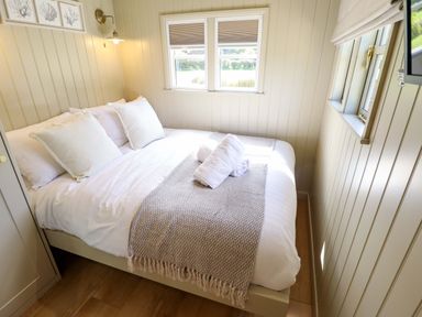 A bedroom with a bed and pillows at Snowdrop in Grimsby