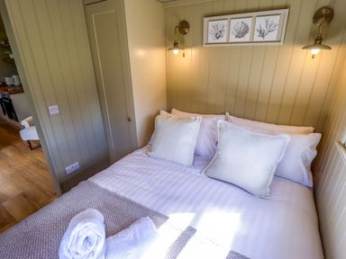 A bedroom with a bed and wall art at Snowdrop in Grimsby