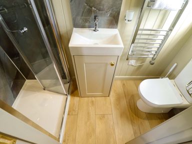 A bathroom with a shower, sink, and toilet at Snowdrop in Grimsby