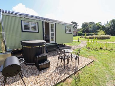 An outdoor area with a trailer and seating at Snowdrop in Grimsby