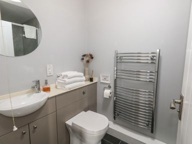 A bathroom with a sink toilet towels and a heated towel rail at Stapleford Farm in Hooke near Beaminster