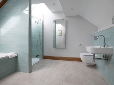 A bathroom with a shower and bathtub at Trevean in Mullion
