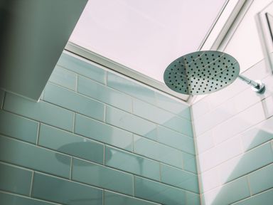 A shower head with tiled walls and a skylight at Trevean in Mullion