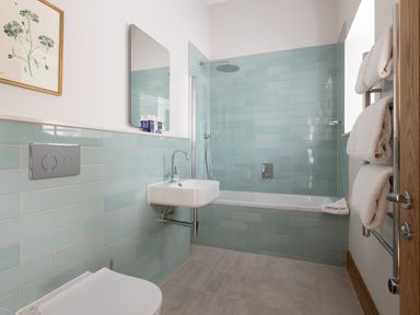 A bathroom with a shower and bathtub at Trevean in Mullion