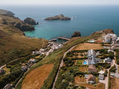 A coastal view with houses and a harbor at Trevean in Mullion