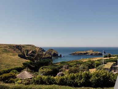 A coastal view with cliffs and islands at Trevean in Mullion