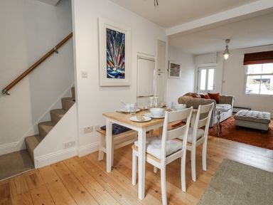 A dining area with table and chairs at Fisherman’s Cottage