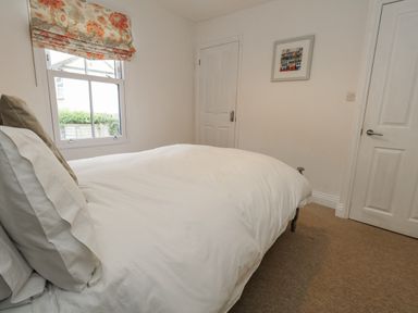A bedroom with a bed and window at Fisherman’s Cottage in 