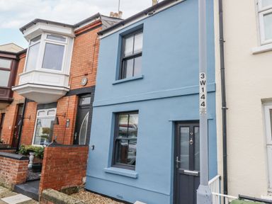A blue house with a door and windows at Fisherman’s Cottage