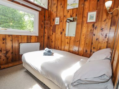 A bedroom with a bed and window at Ty Bedwen in Dinas Mawddwy