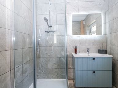 A bathroom with a shower and sink at Tirionfa in Talsarnau