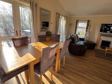 A living room with a dining table and a sofa at Woodland View 31 - The Hawthorns near Finlakes Holiday Park