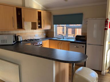 A kitchen with cabinets, stove, sink, and refrigerator at Woodland View 31 - The Hawthorns near Chudleigh