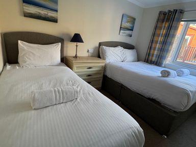 A bedroom with two single beds at Woodland View 31 - The Hawthorns near Chudleigh