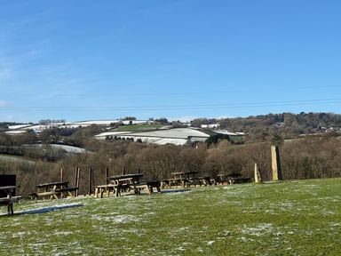 A view of tables and chairs in a snowy landscape at Woodland View 31 - The Hawthorns near Finlakes Holiday Park