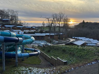 A water slide and cabins with trees at Woodland View 31 - The Hawthorns Finlakes Holiday Park near Chudleigh