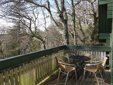 A balcony with table and chairs at Tor View Finlakes Holiday Park near Chudleigh
