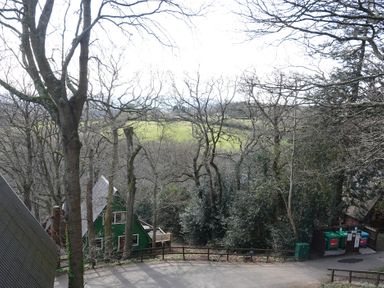 An outdoor view of trees, buildings and a field at Tor View in Finlakes Holiday Park near Chudleigh