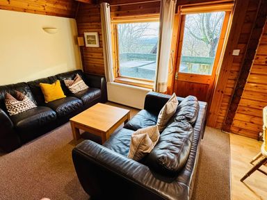A living room with a coffee table and sofas at Tor View Finlakes Holiday Park near Chudleigh