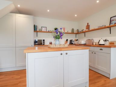 A kitchen with cabinets and appliances at Glendale in Port Isaac