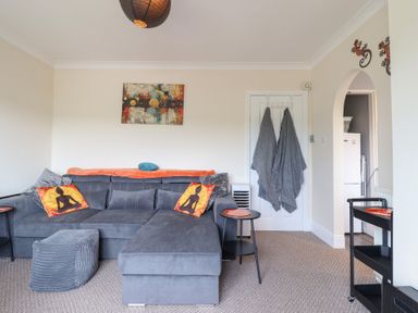 A living room with a sofa and coffee table at Golygfa Pandy Tudur near Llanrwst