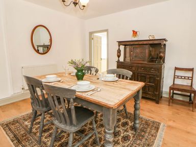 A dining room with a table and chairs at Llain in Cardigan
