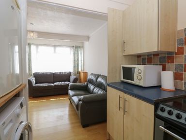 A kitchen area with a sofa and appliances at 440 California Sands