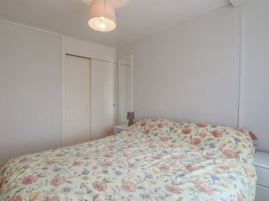 A bedroom with a bed and a bedside lamp at 440 California Sands
