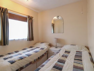 A bedroom with two beds and a lamp at 440 California Sands