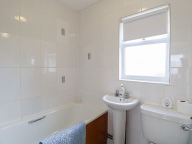 A bathroom with a bathtub, sink, and toilet at 440 California Sands