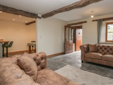A living room with sofas and a table at Howgill Head in Kendal