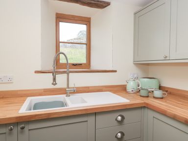 A kitchen with a sink and appliances at Howgill Head in Kendal