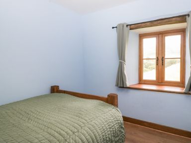 A bedroom with a bed and a window at Howgill Head in Kendal