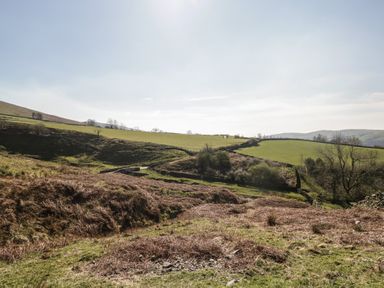 A landscape with fields and hills at Howgill Head in Kendal