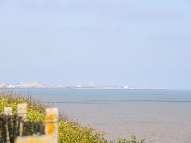 A coastal view with water and industrial buildings in the distance at 98 Waterside Park in Corton