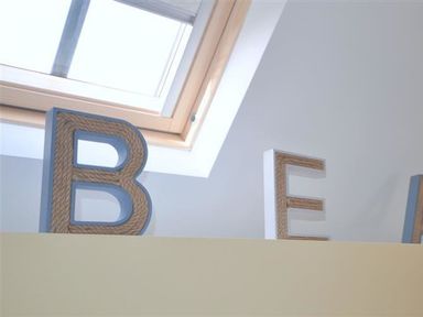 Decorative letters B and E on a shelf under a skylight window at Sunset Lodge in Fortuneswell