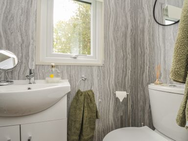 A bathroom with a sink and toilet at Buzzards Lodge in Roche
