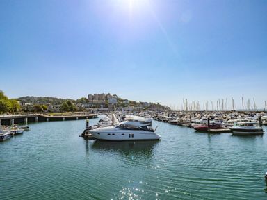 A marina with boats and buildings at Harcombe House Rooms - First Floor King in Chudleigh