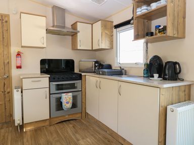 A kitchen with stove oven microwave sink countertop and cabinets at 4 Foxburrow Hang in Fritton near Belton Norfolk