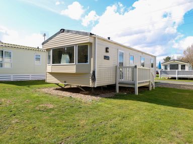 A mobile home with a small porch and steps on a grassy area at 4 Foxburrow Hang in Fritton near Belton Norfolk