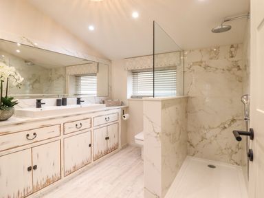 A bathroom with a double sink vanity and a walk-in shower at 6 Uppergate Street Rose Cottage in Conwy