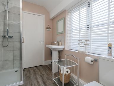A bathroom with shower and sink at Shrimp Cottage in Brewers Quay Harbour