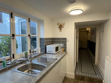 A kitchen with a sink and microwave at Shrimp Cottage Brewers Quay Harbour
