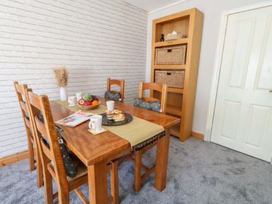 A dining room with a table and chairs at Lily's Pad in Weston, Portland