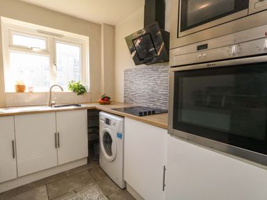 A kitchen with sink, appliances and countertop at Lily's Pad in Weston, Portland