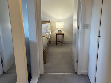 A bedroom with a bed and a lamp at Bracken Cottage
