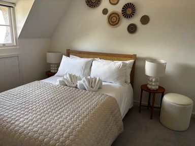 A bedroom with a bed and bedside tables at Bracken Cottage in Osmington