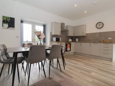 A kitchen with a table and chairs at Birch Cottage in Scarborough