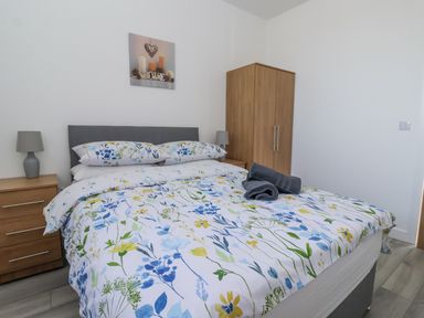A bedroom with a bed and bedside table at Birch Cottage in Scarborough