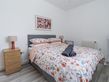 A bedroom with a bed and bedside table at Birch Cottage in Scarborough